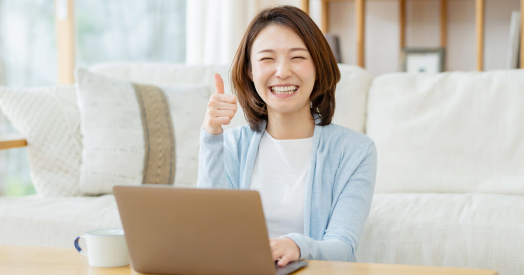 A woman smiling in front of her computer